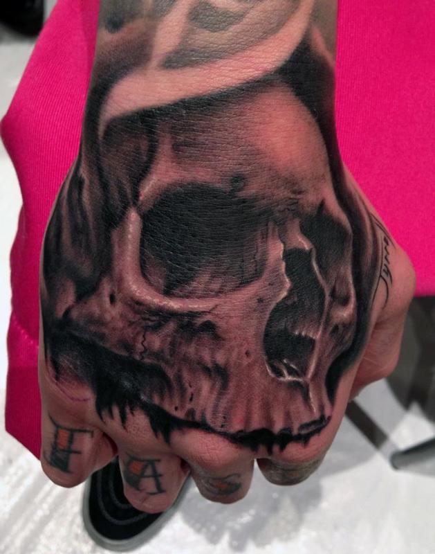 Skull hand tattoo by Bob Tyrrell Tattoos