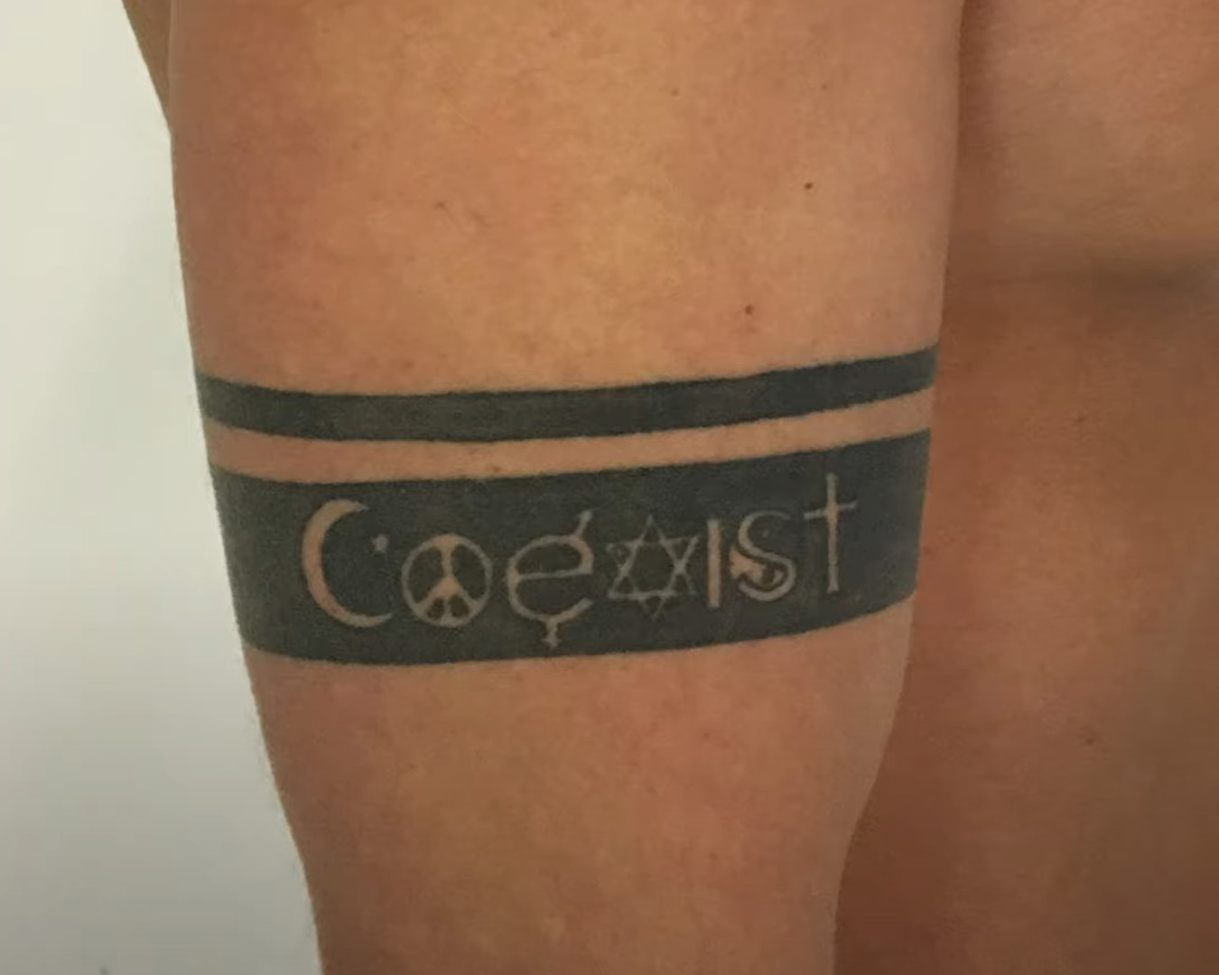Coexist armband tattoo before cover up