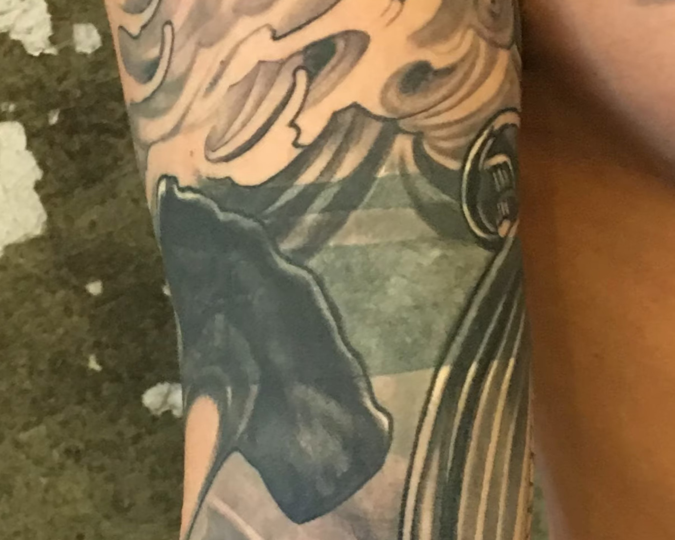 adding in gray ink to cover up black armband tattoo