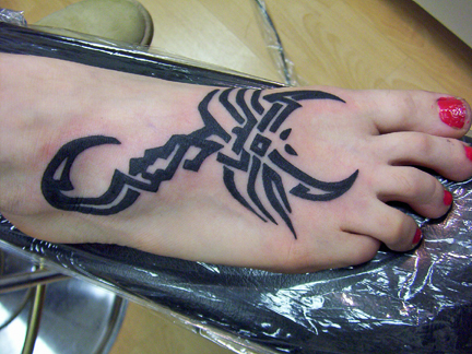 tribal scorpion tattoo on foot