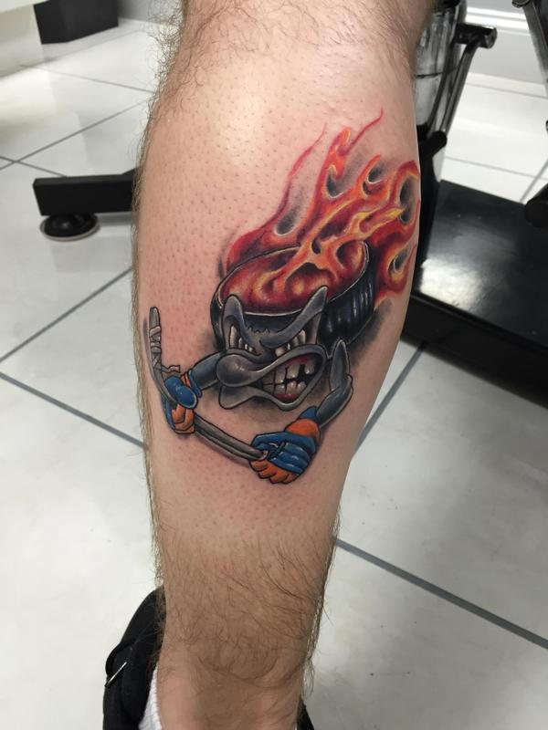 Hockey Puck flesh tear tattoo