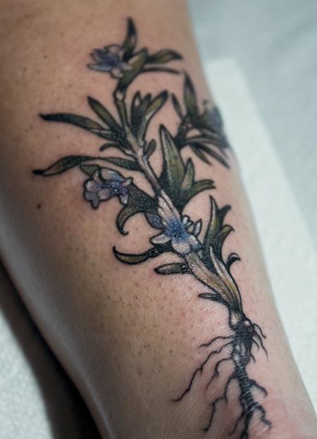 Rosemary colour flower tattoo on the upper back halter neck top brunette  hair Stock Photo - Alamy