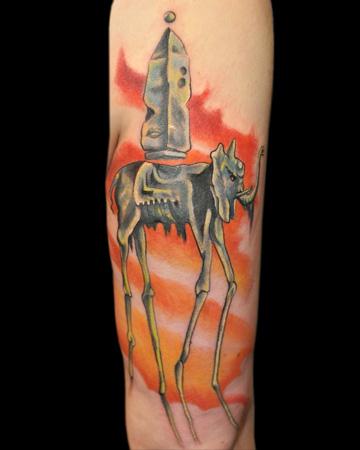 Salvador Dalí inspired elephant tattoo on the upper
