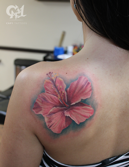 Hibiscus flower tattoo on the left thigh.