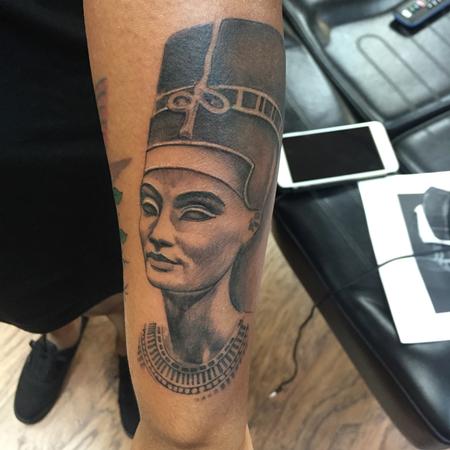 Fine line Nefertiti tattoo located on the forearm.