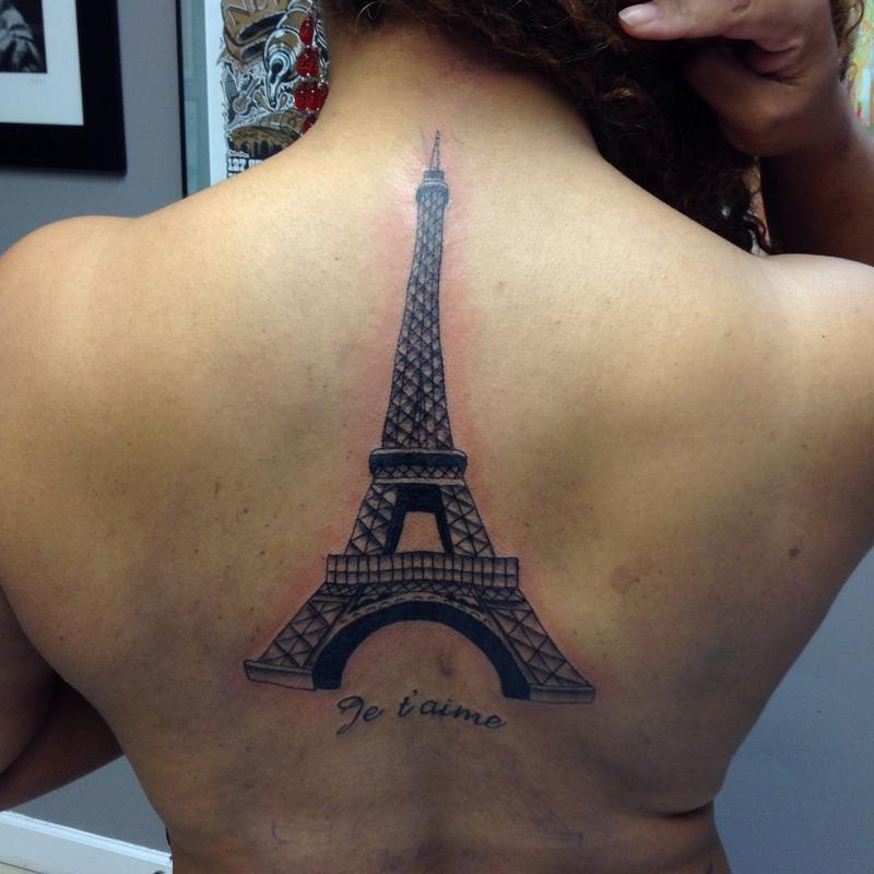 Fine line Eiffel Tower tattoo on the shoulder
