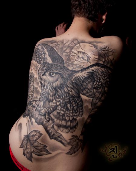 Owl skull tattoo on the back.