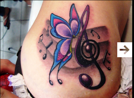 Elle est Forte text tattoo with a butterfly done 
