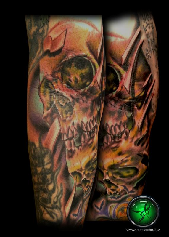 tribal skull arm tattoo