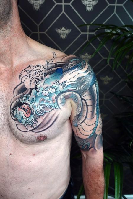 Chinese water dragon tattoo on the right upper arm