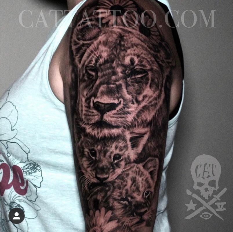 Lioness and lion cub tattoo located on the inner
