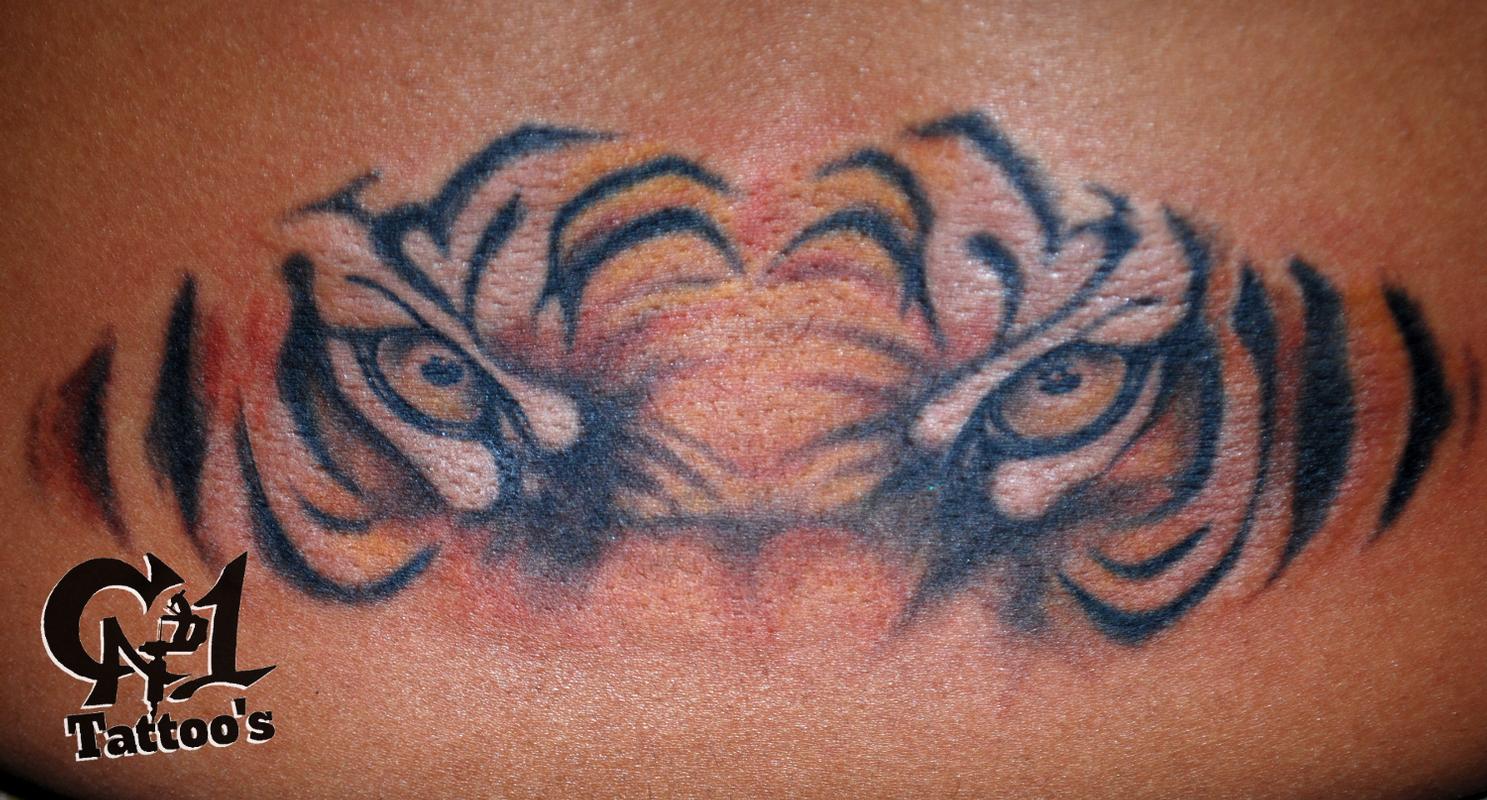 tiger eyes tattoos lower back