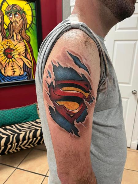 Superman tattoo on the inner forearm.