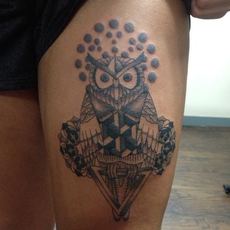 Owl tattoo on the left upper arm.