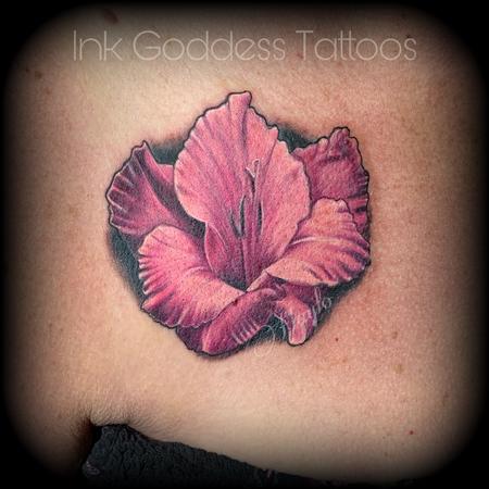 Fine line poppy and gladiolus flowers tattooed on the