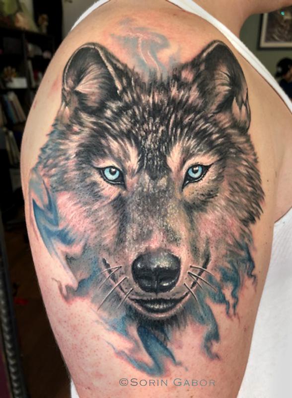 Wolf tattoo on the left shoulder and chest.