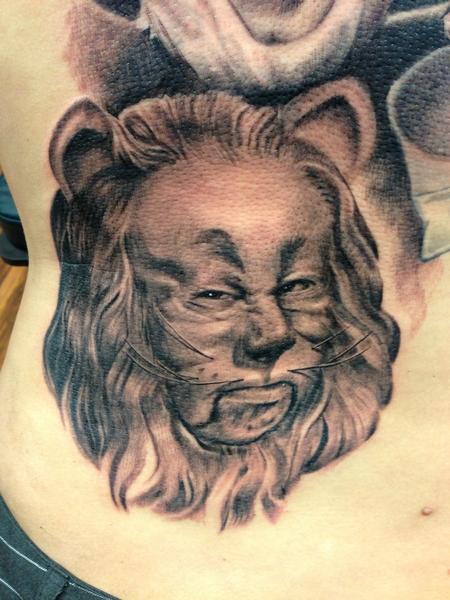 Micro-realistic lion portrait tattoo located on the